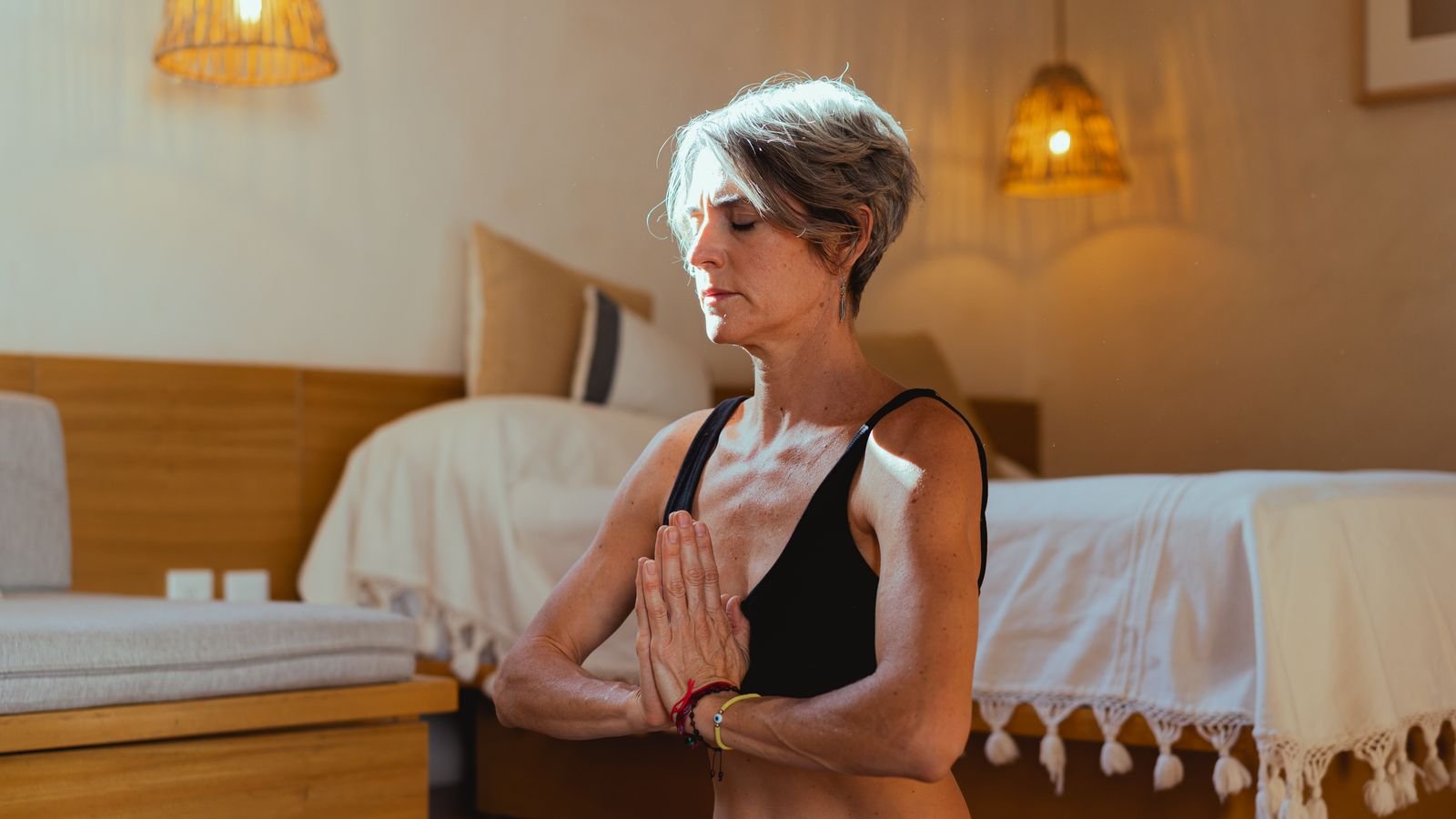 Person meditating peacefully in a calm, minimalist room