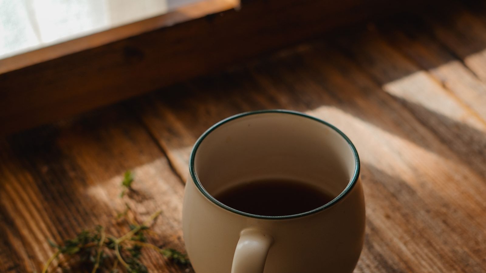 Cup of coffee by a sunlit window during a calm morning routine