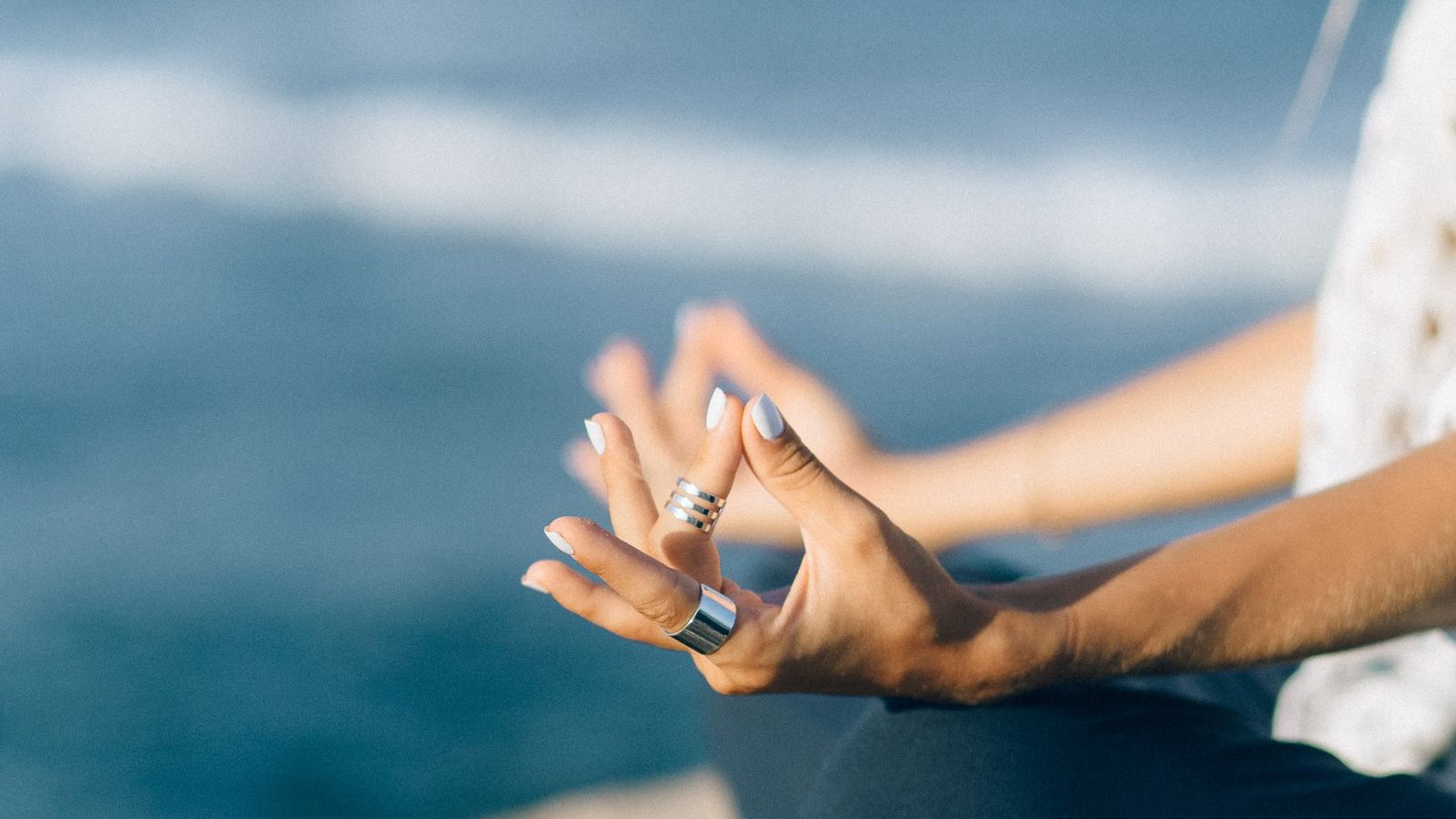 Person meditating with eyes closed in soft natural light